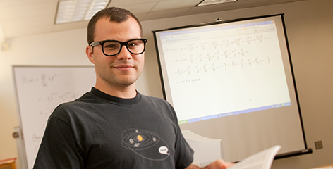 Male math student standing before class